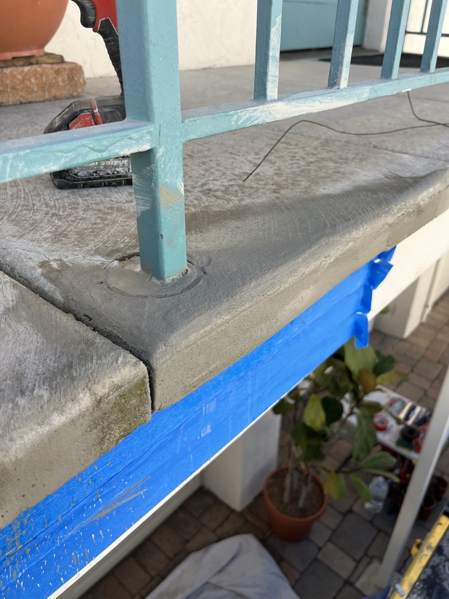 Shaped concrete repair around the handrail post with blue edge protection still in place